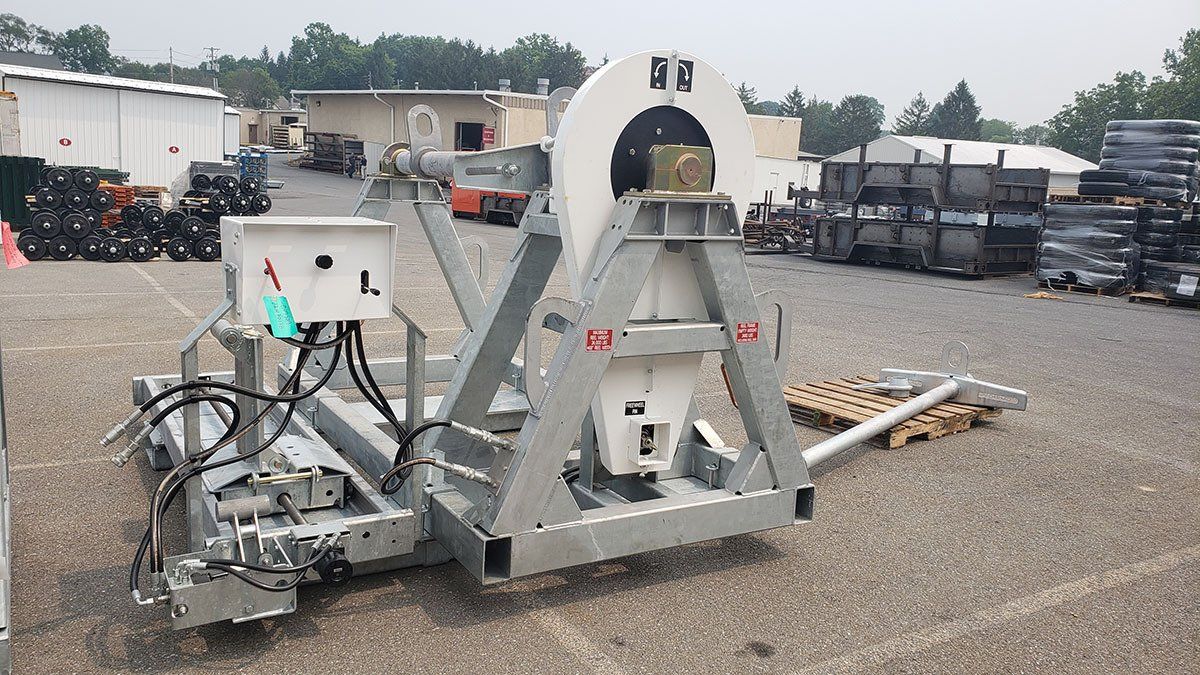A large machine is sitting in a parking lot.