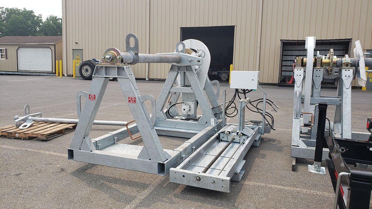 A large machine is sitting in a parking lot in front of a building.