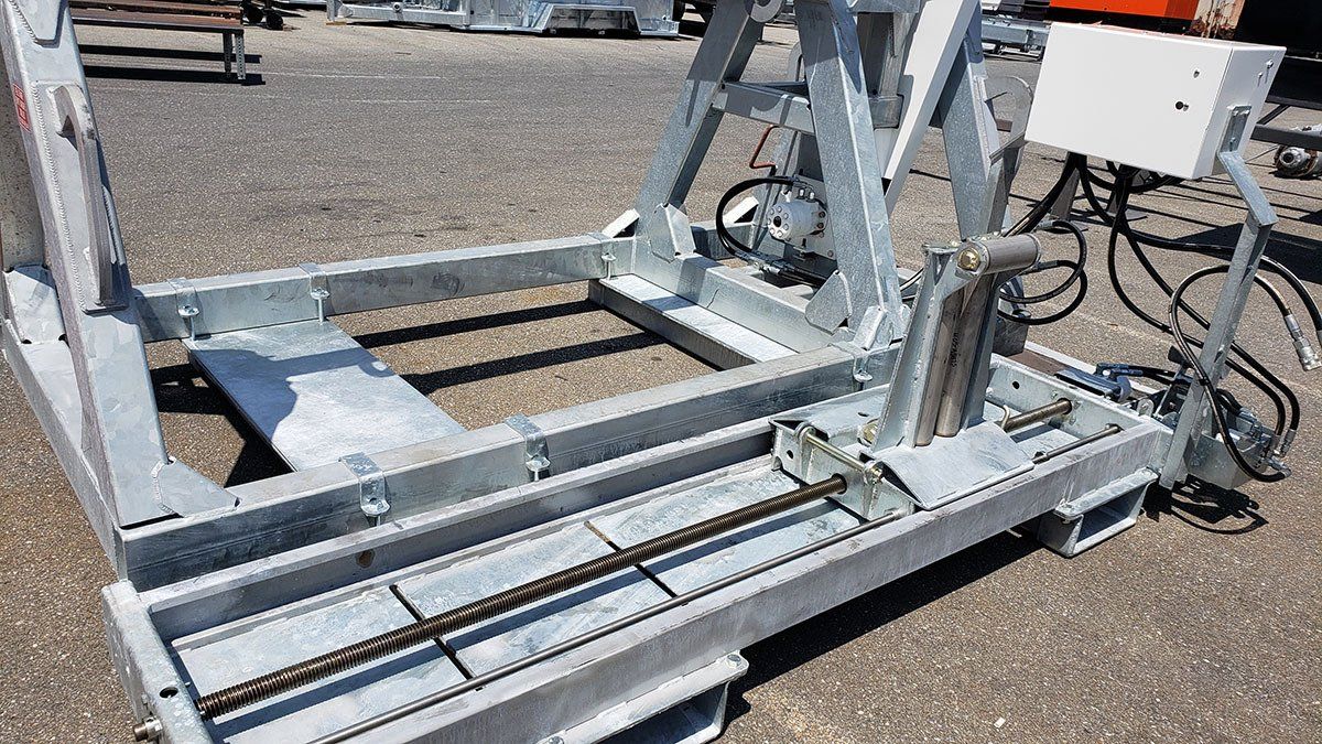 A metal structure is sitting on the ground in a parking lot.