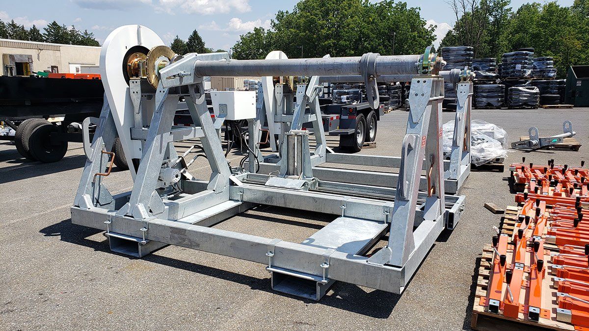 A large metal structure is sitting on the ground in a parking lot.