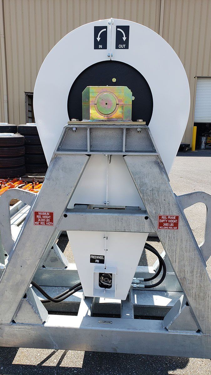 A white machine is sitting on a metal frame in front of a building.