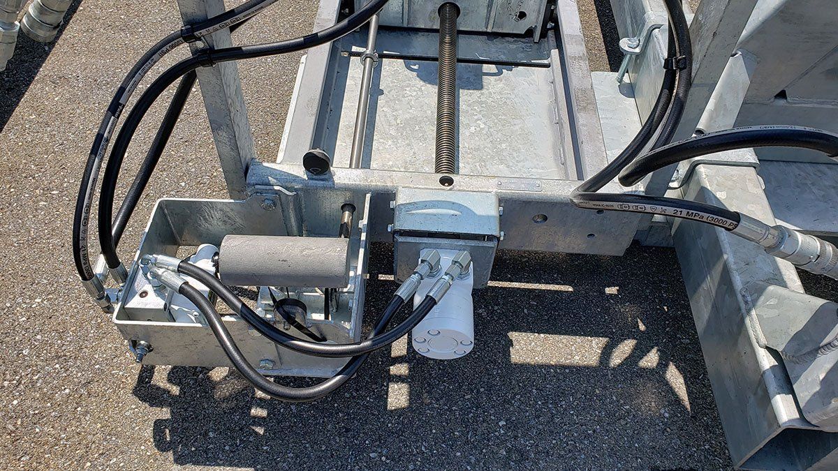 A close up of a machine with hydraulic hoses attached to it.