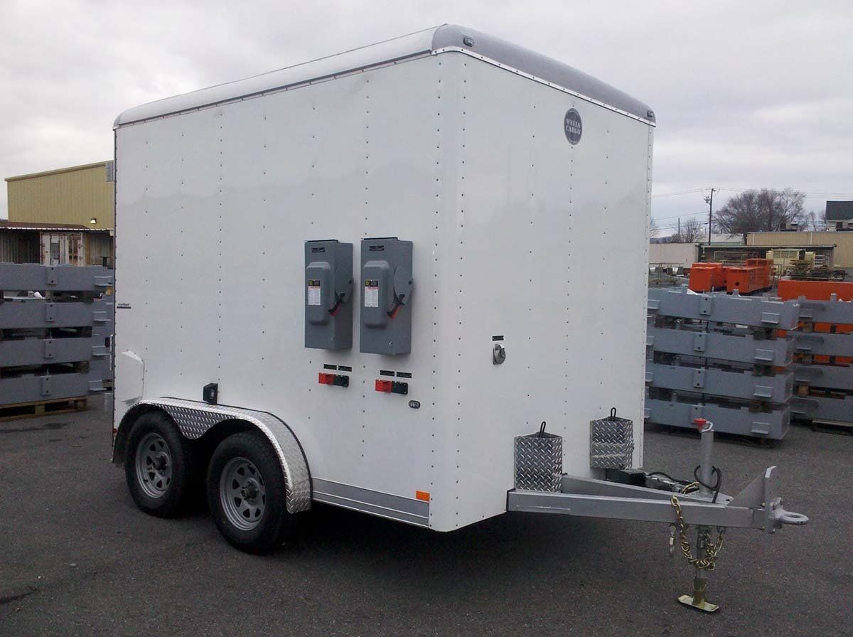 A white trailer is parked in a parking lot