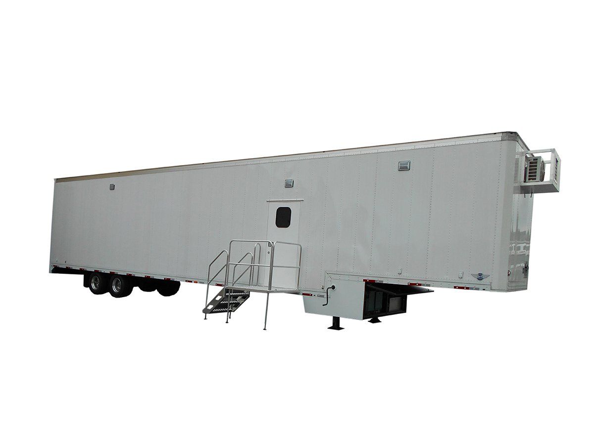 A large white trailer with stairs attached to it on a white background.