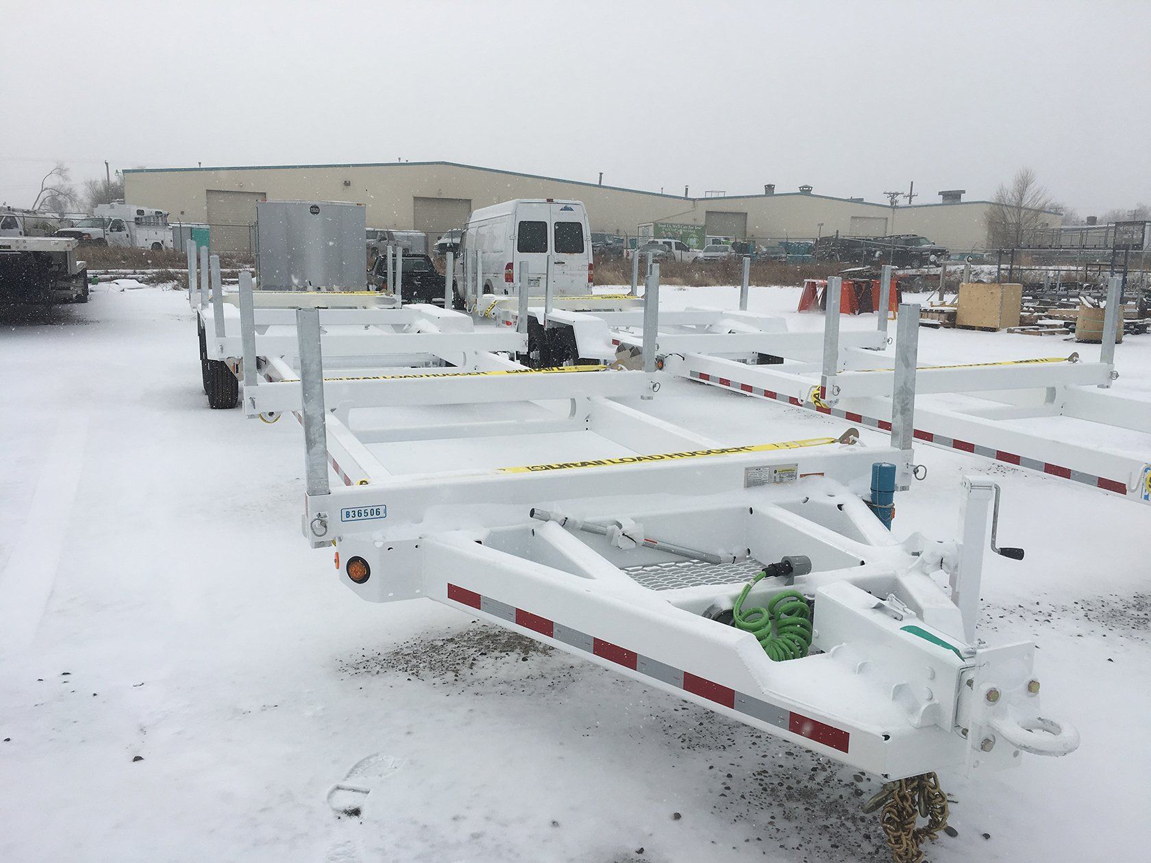 A trailer is sitting in the snow in front of a building