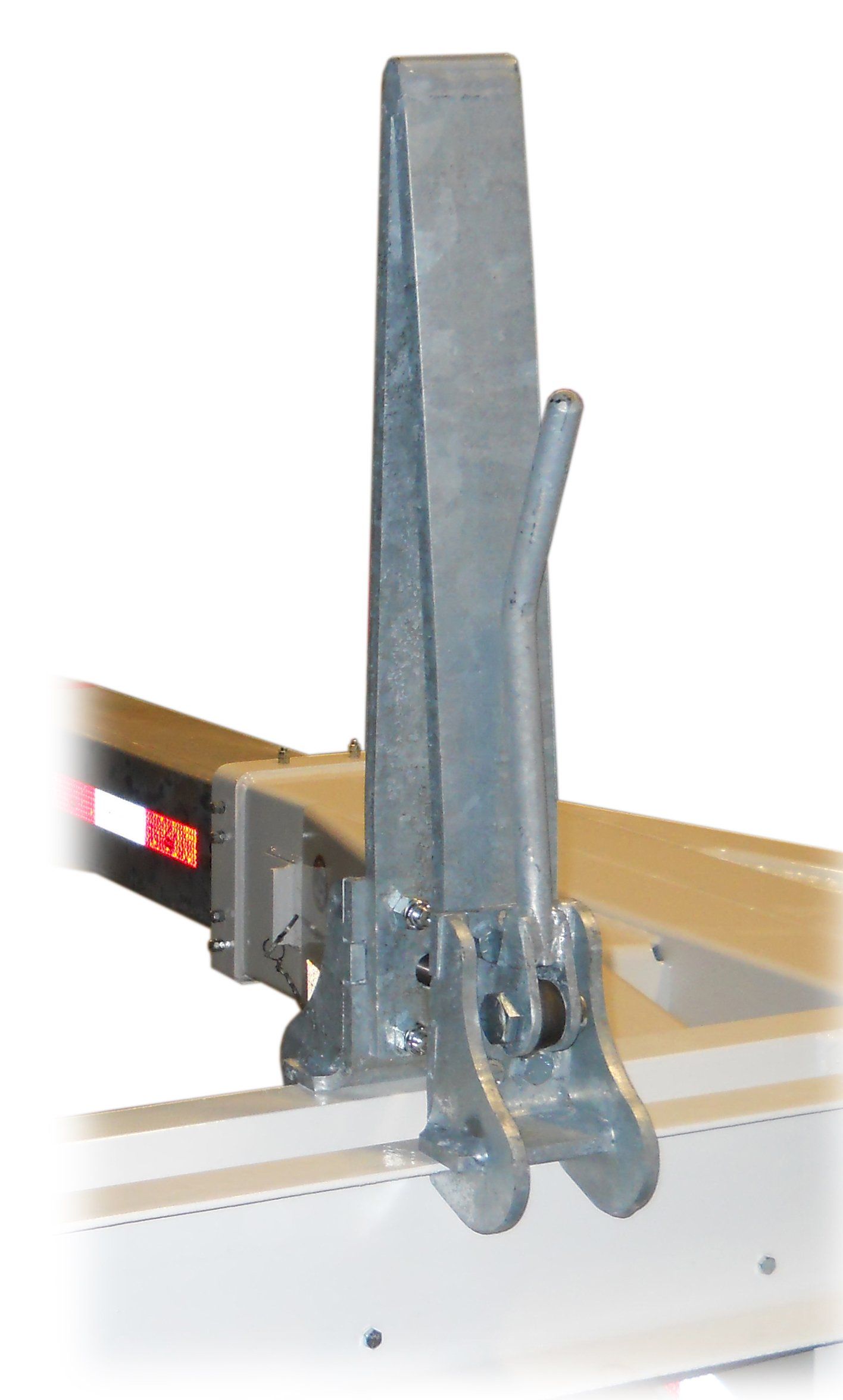A metal clamp is attached to a piece of wood.