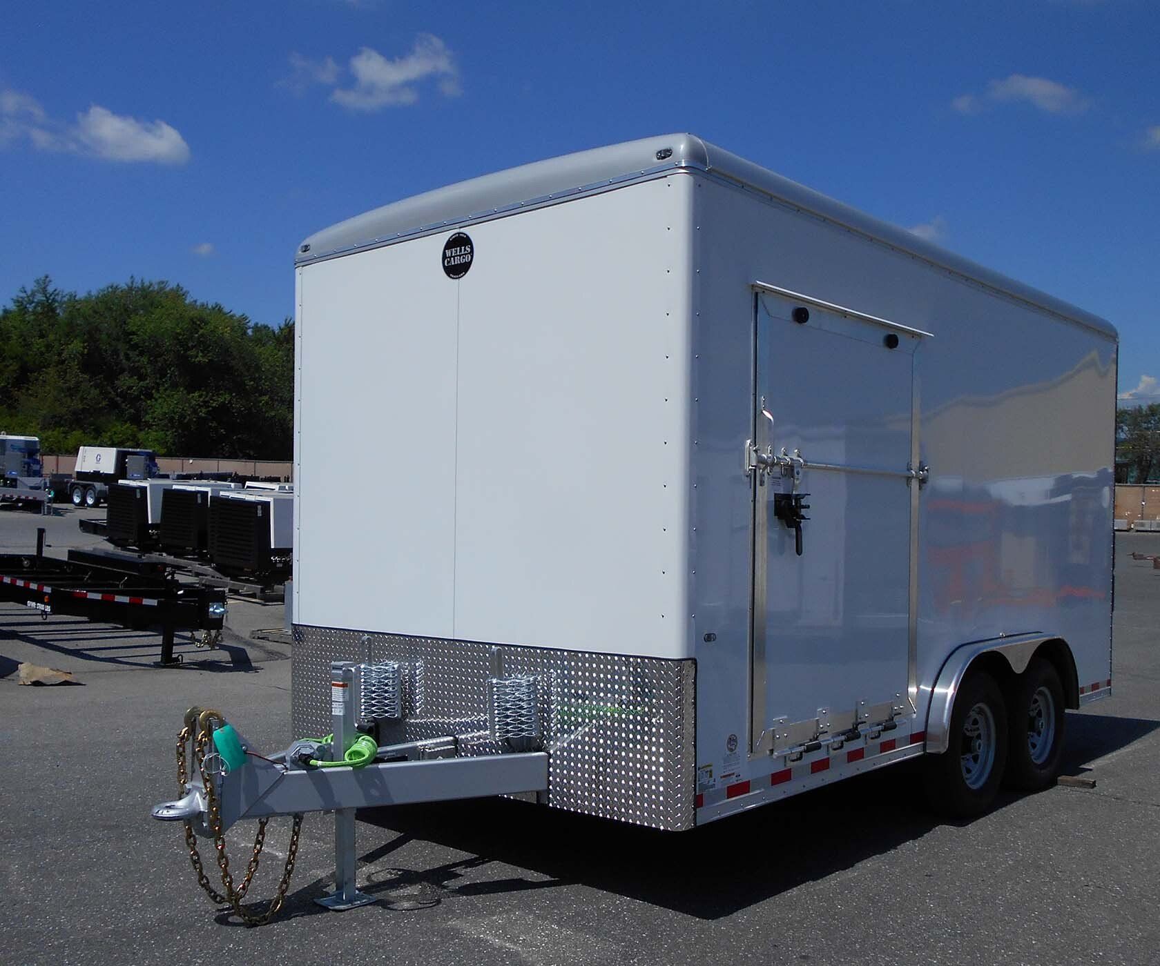 A white trailer is parked in a parking lot