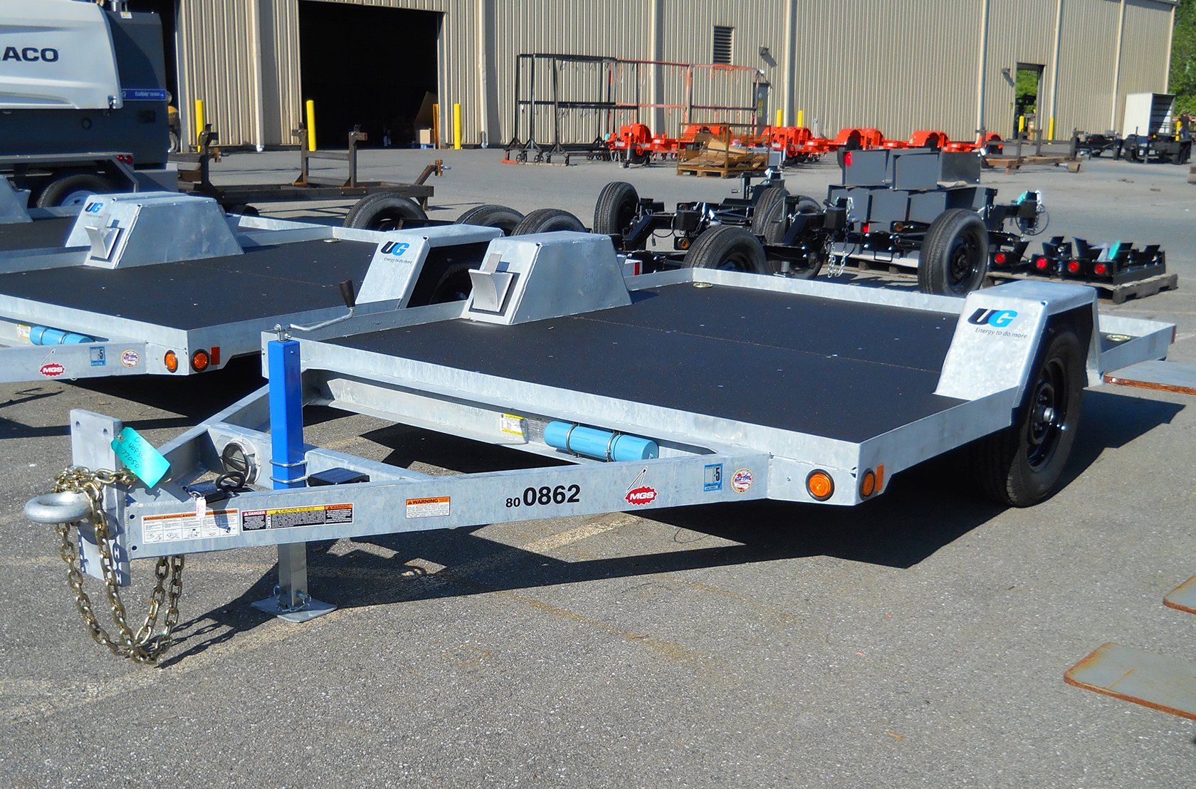 Two trailers are parked next to each other in a parking lot