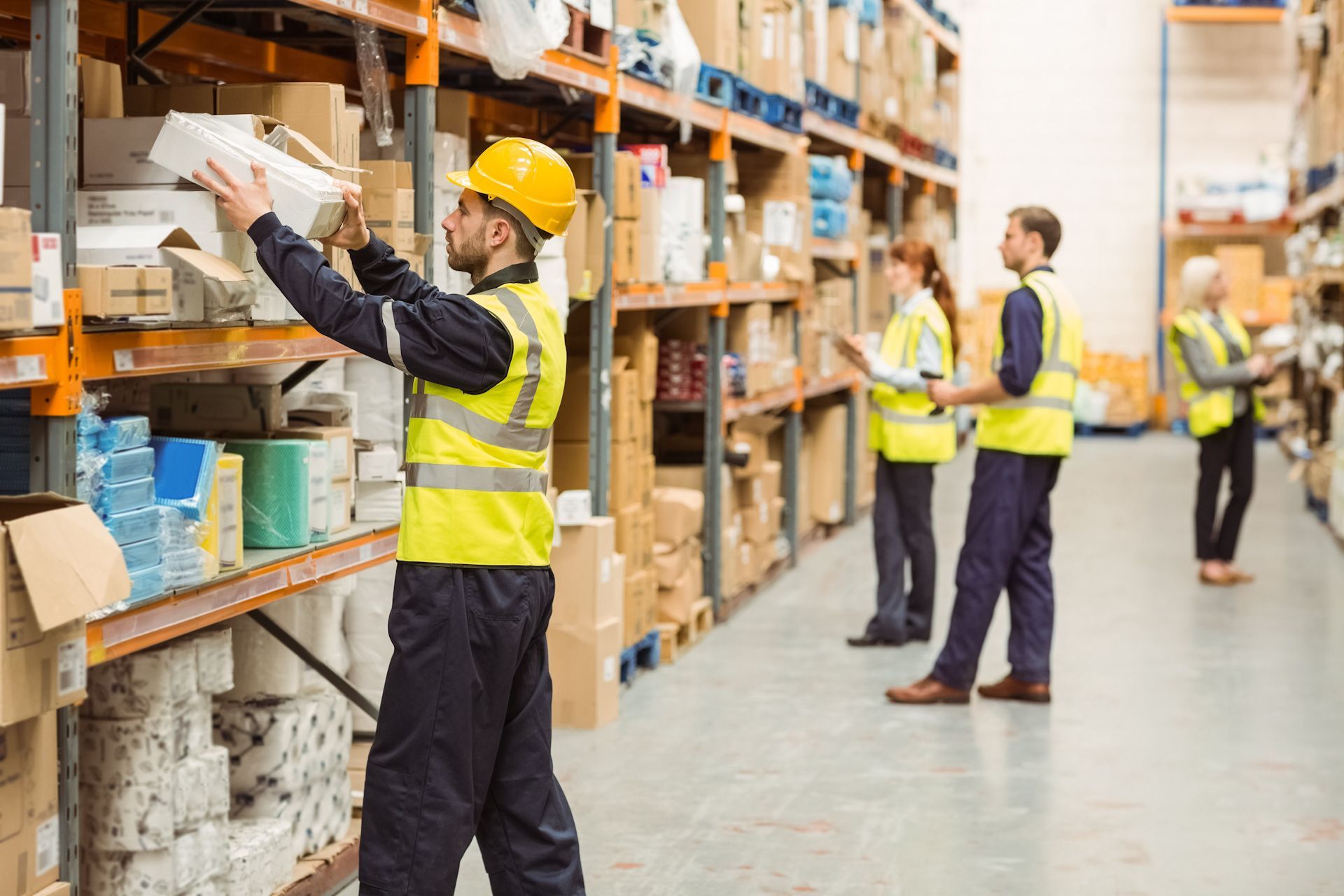 A group of workers are working in a warehouse.