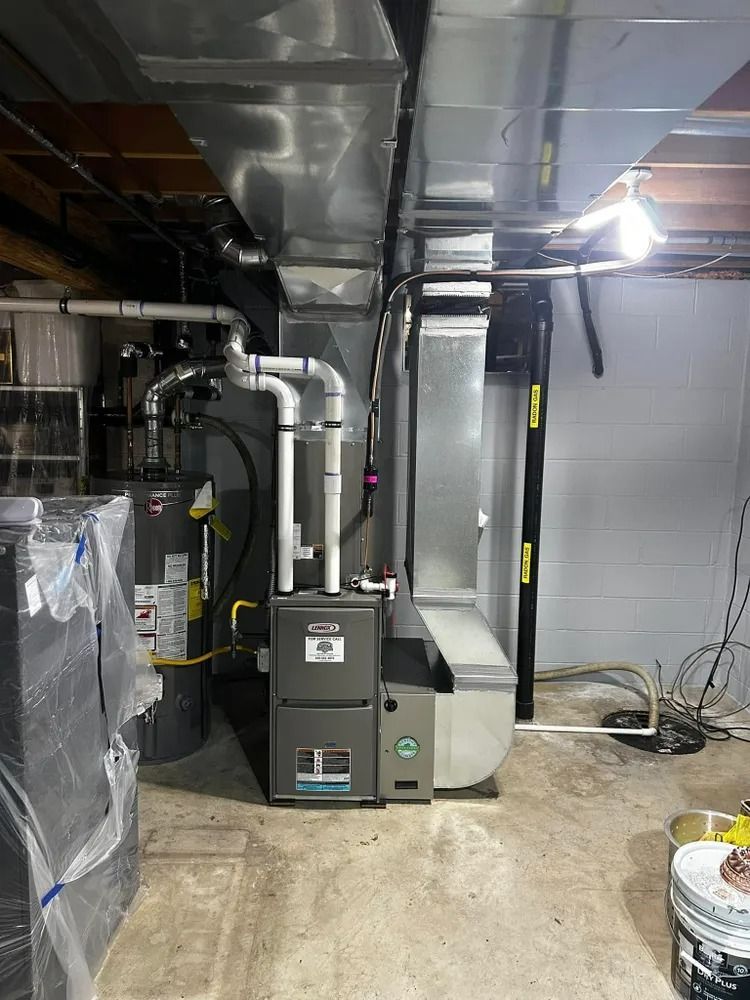 A basement with a furnace and air conditioner in it.
