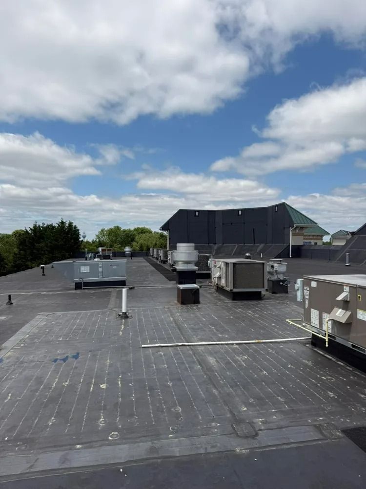 The roof of a building with a lot of air conditioners on it