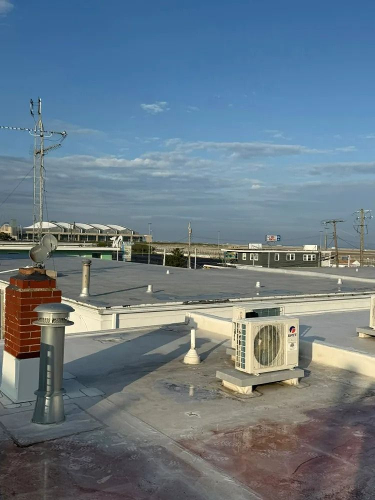 A rooftop with a lot of air conditioners on it