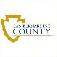 The logo for san bernardino county has a shield on it.