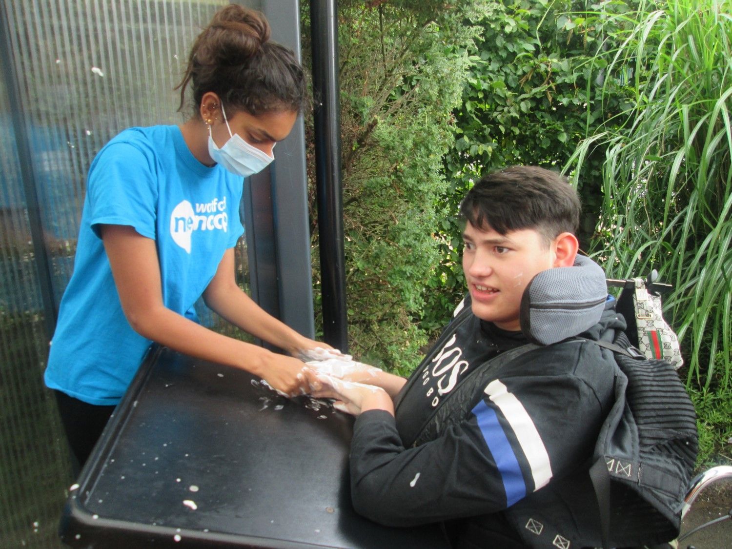 A Support Worker and a service user. 