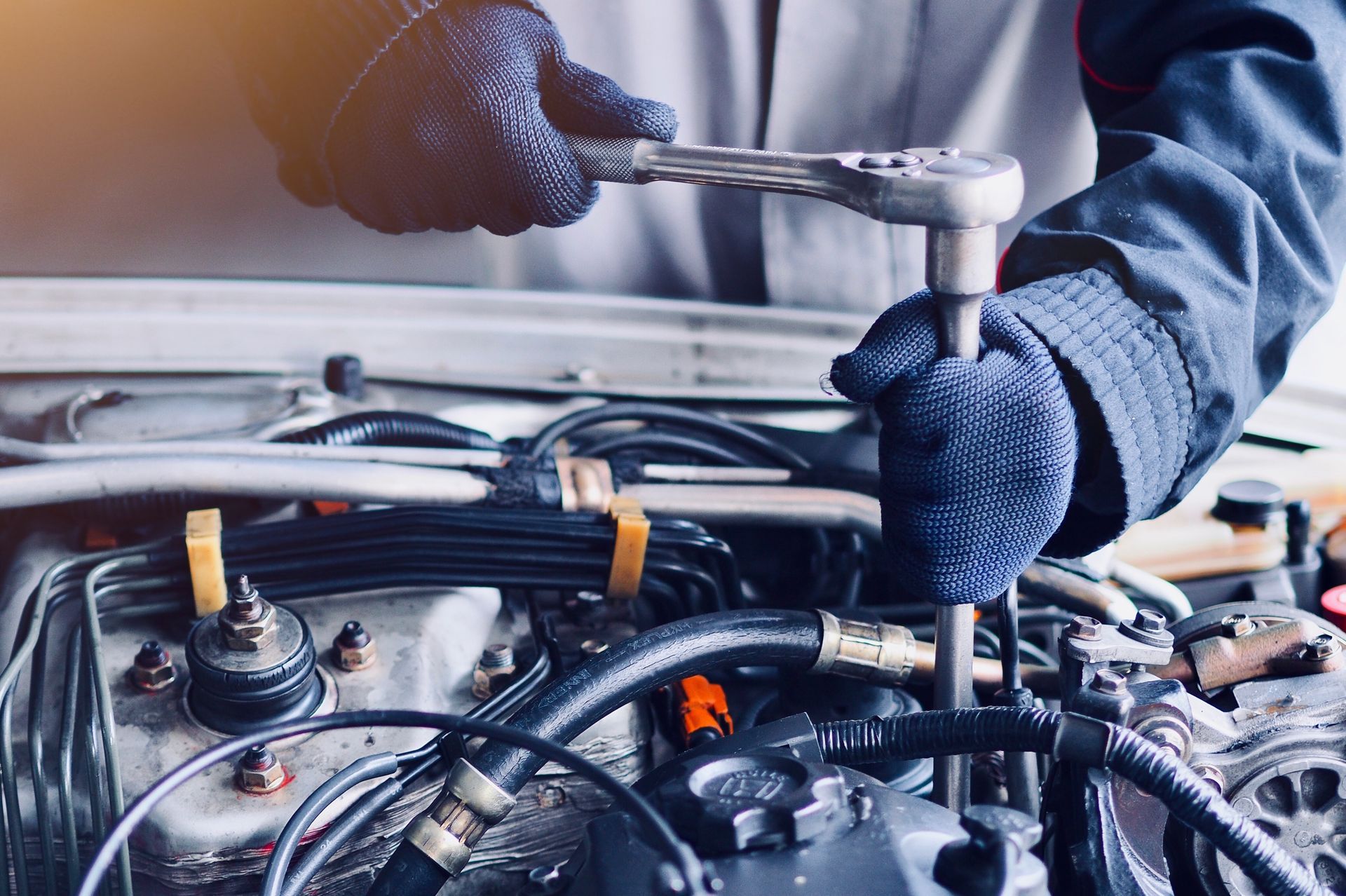 Skilled technician performs commercial truck repair on a complex diesel engine with tools. Skilled technician performs commercial truck repair on a complex diesel engine with tools.