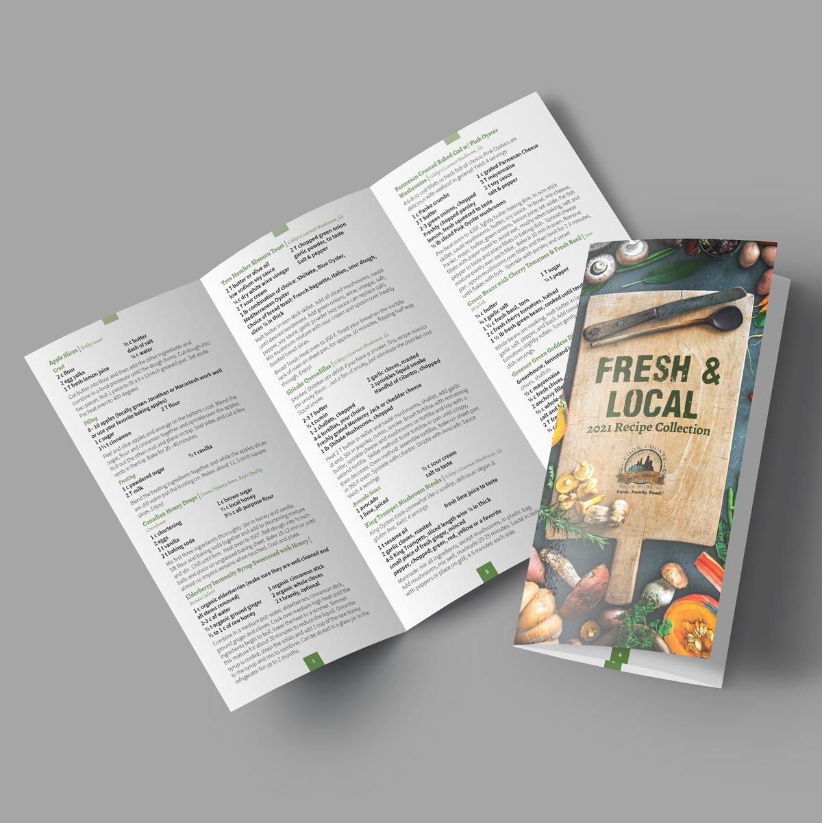 Brochure design of a fresh and local menu is sitting on a table .
