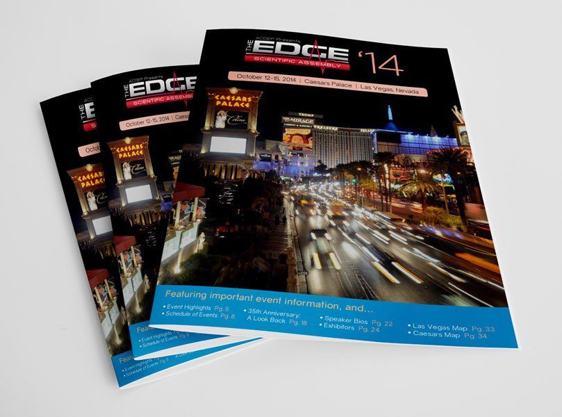 a stack of edge magazines with a picture of a city at night