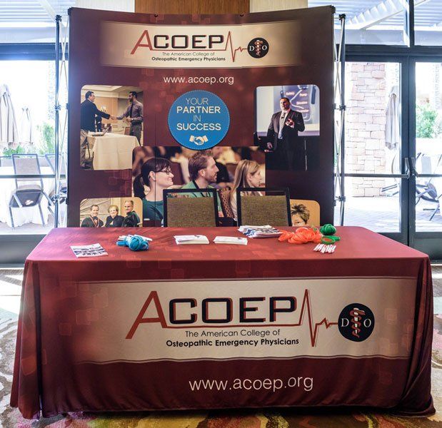 a table with a banner that says acoep on it