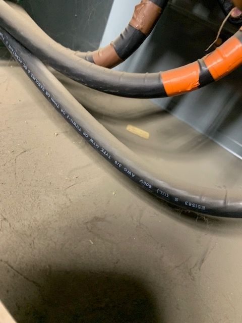 A bunch of wires are laying on a concrete surface