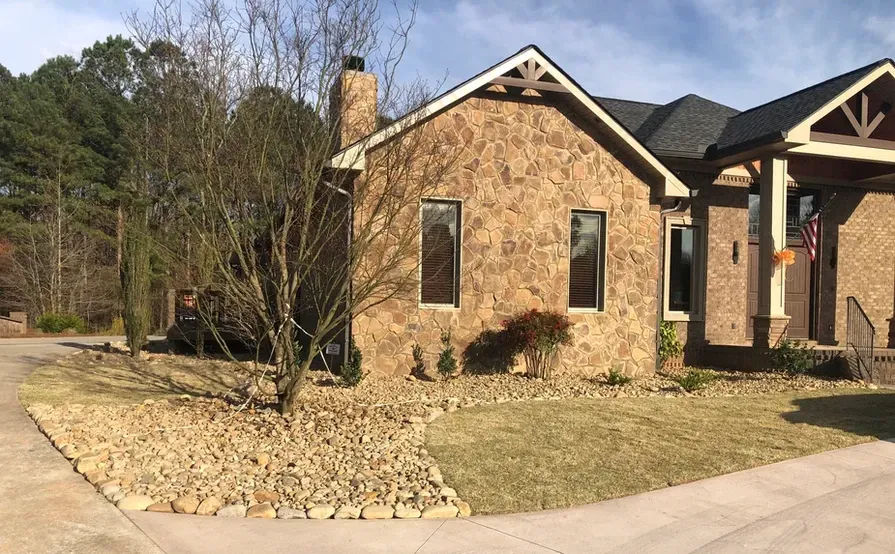 A large brick house with a car parked in front of it