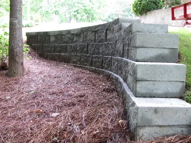 A brick wall with stairs leading up to it.