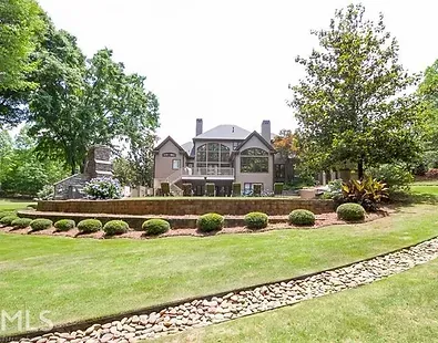 A large house with a large lawn in front of it.