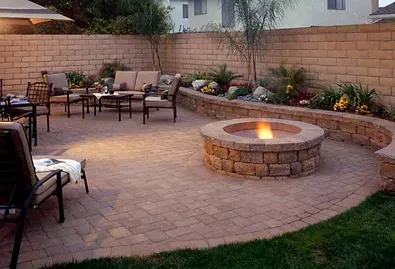 There is a fire pit in the middle of the patio.