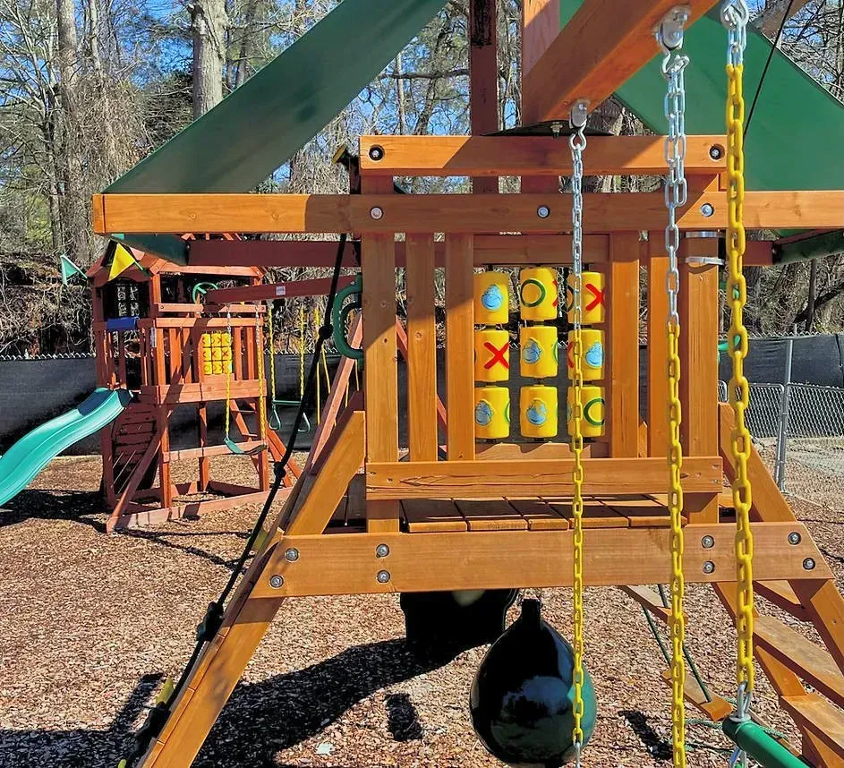 A wooden playground with a tic tac toe board.