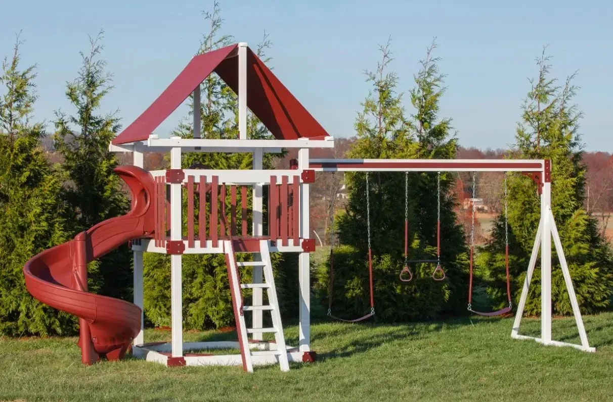 A red and white playground set with a red slide.