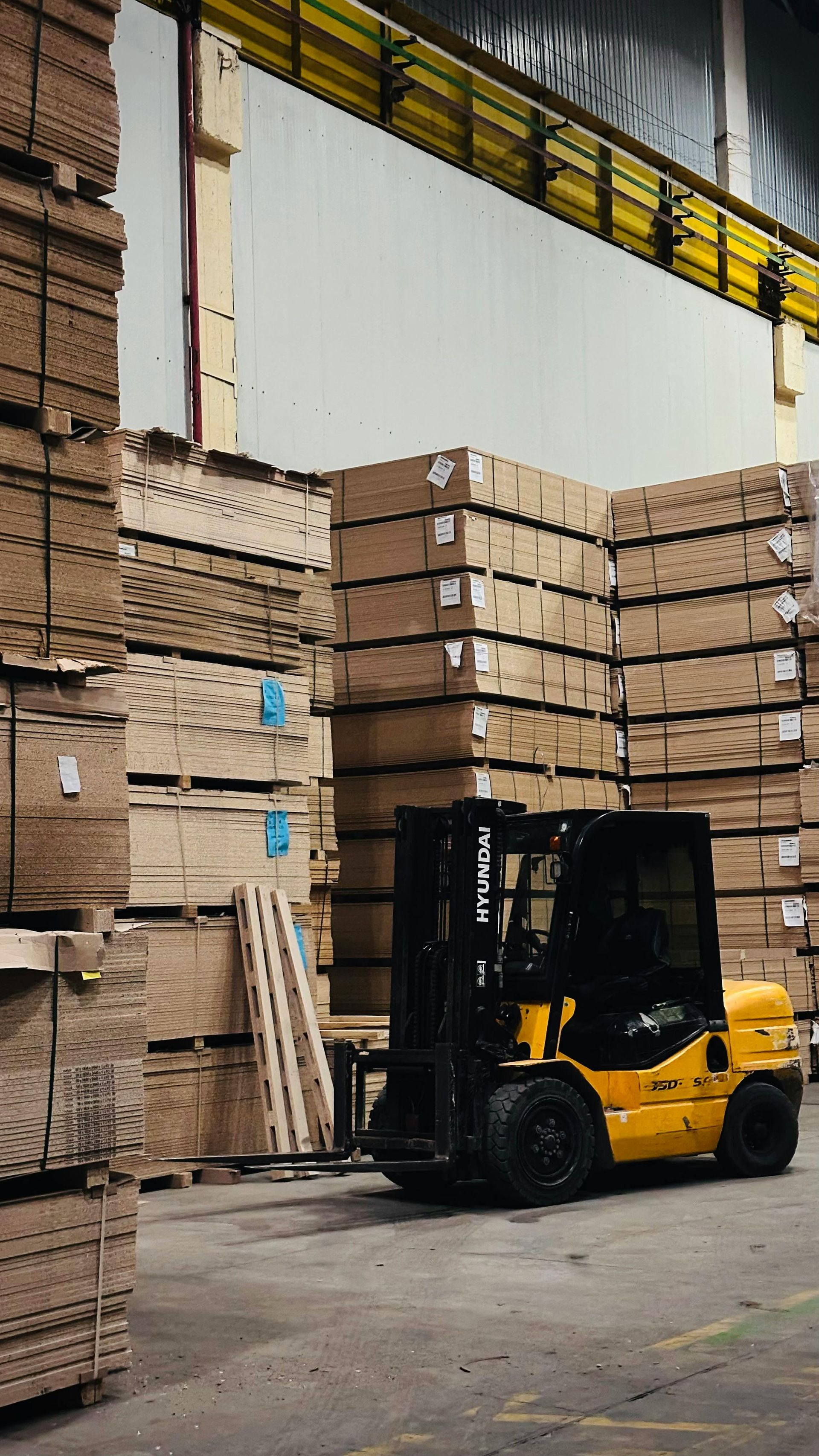 Couple reviewing a document with a person, indoors. They smile, looking at the person who is holding the document.