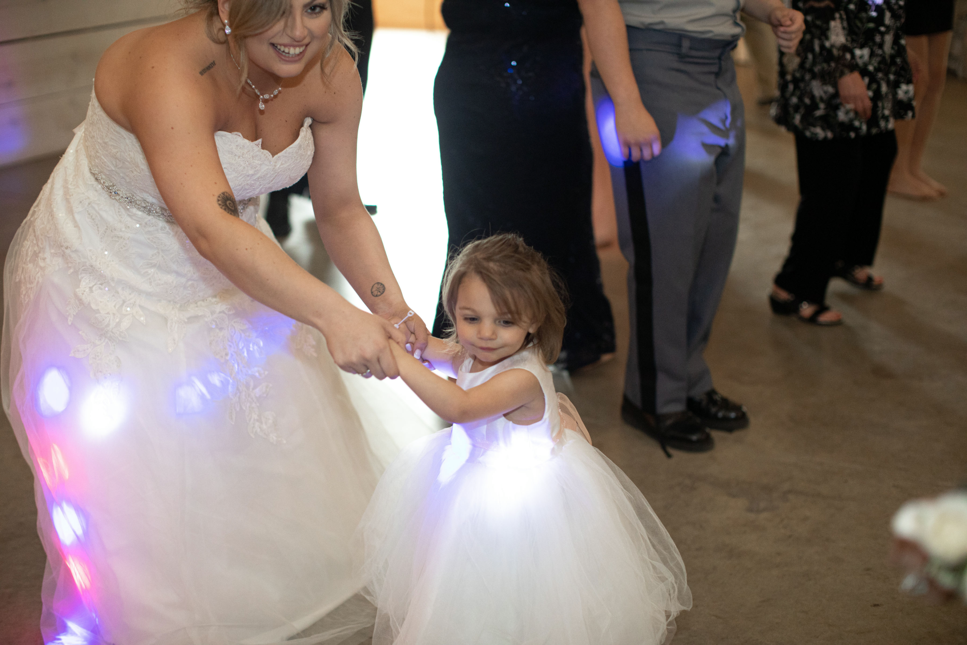 bride and flowergirl dancing