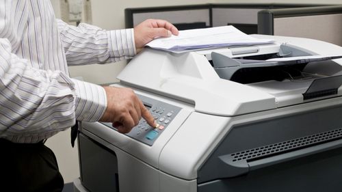 Man Using Copier Printer — Lexington, KY — Bluegrass Office Systems