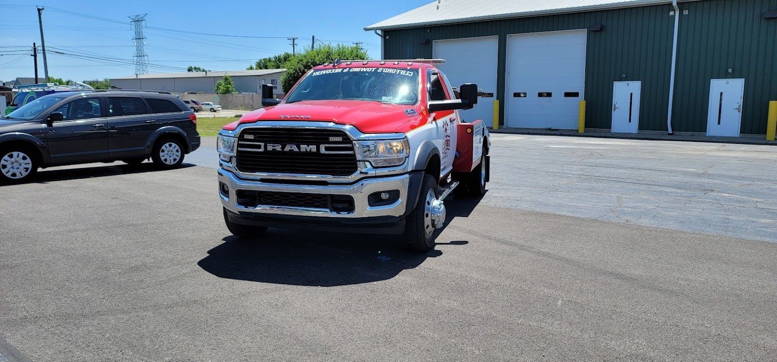 A red ram truck is parked in front of a garage.