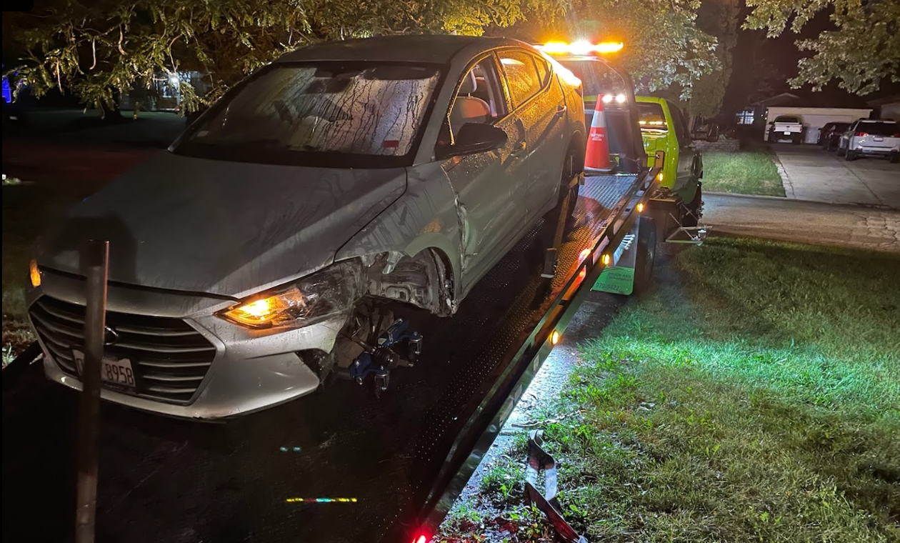 A car is being towed by a tow truck.