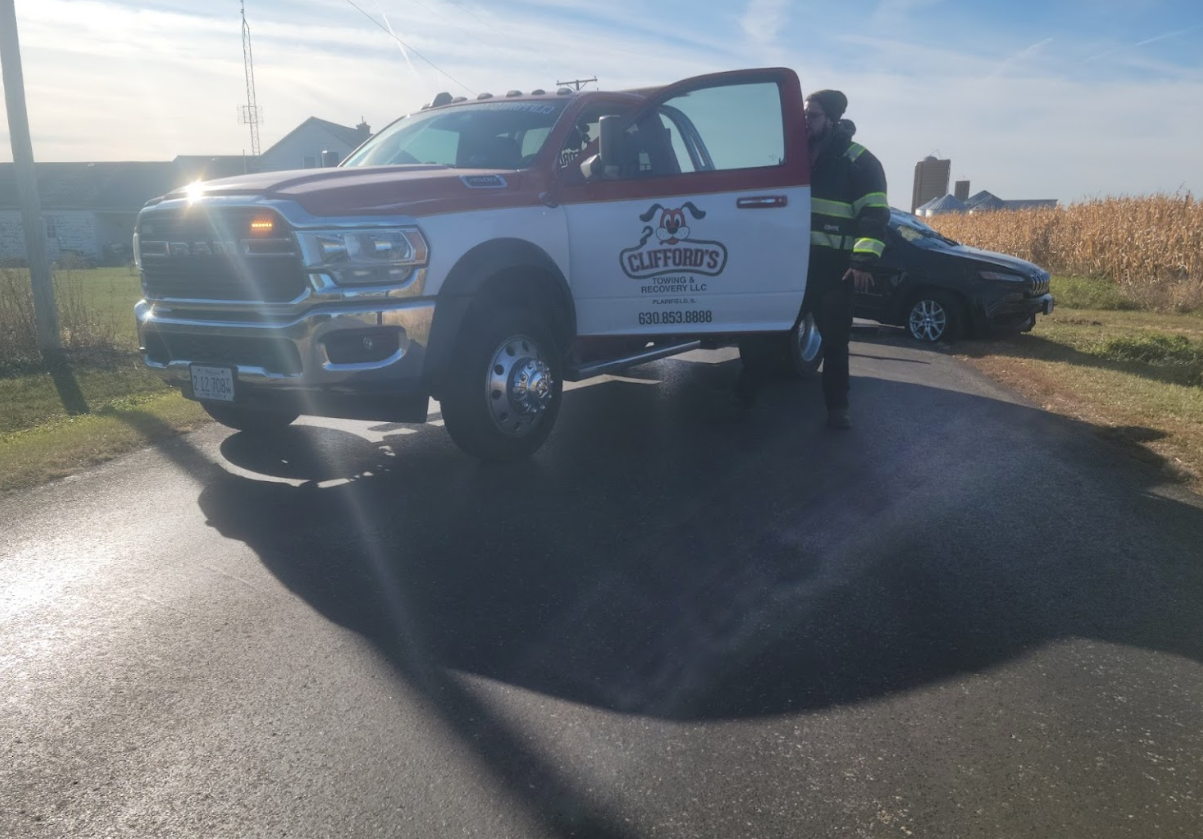 A red and white truck is parked on the side of the road.