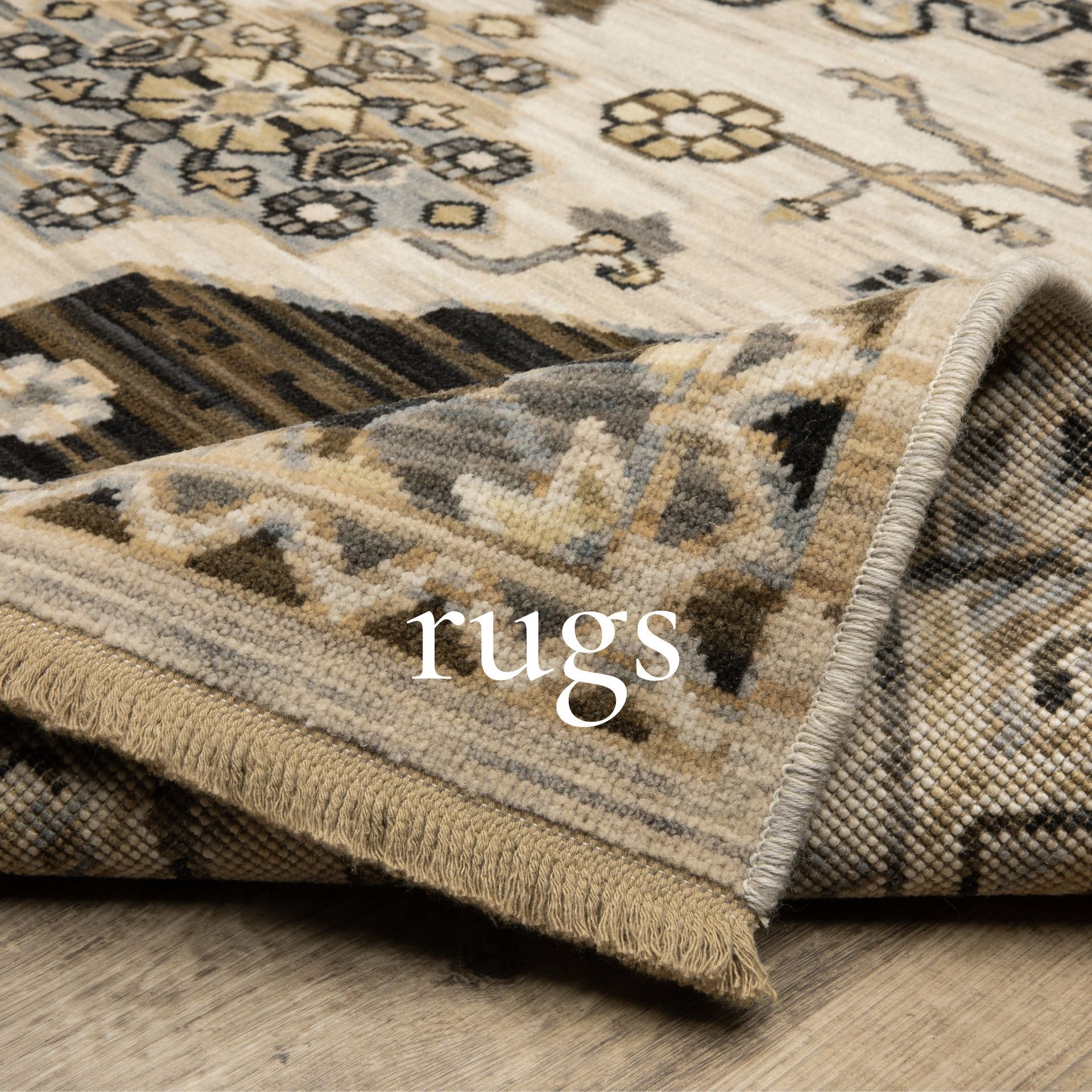 Rolled rugs, varying colors and patterns, displayed against a patterned background.
