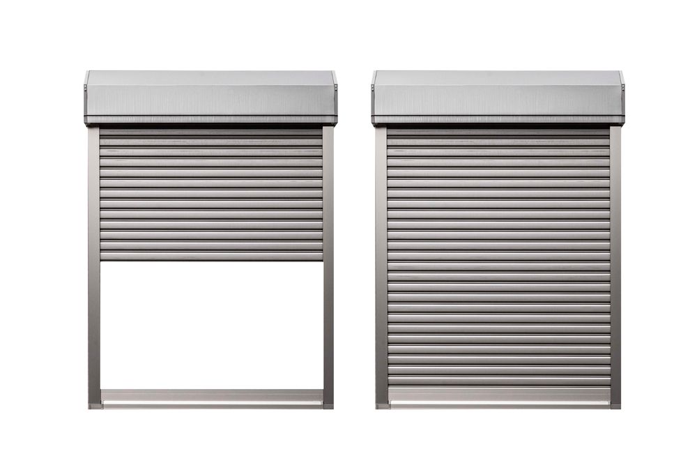 Green velvet sofa in a room with a window, plants, and a gray wall.