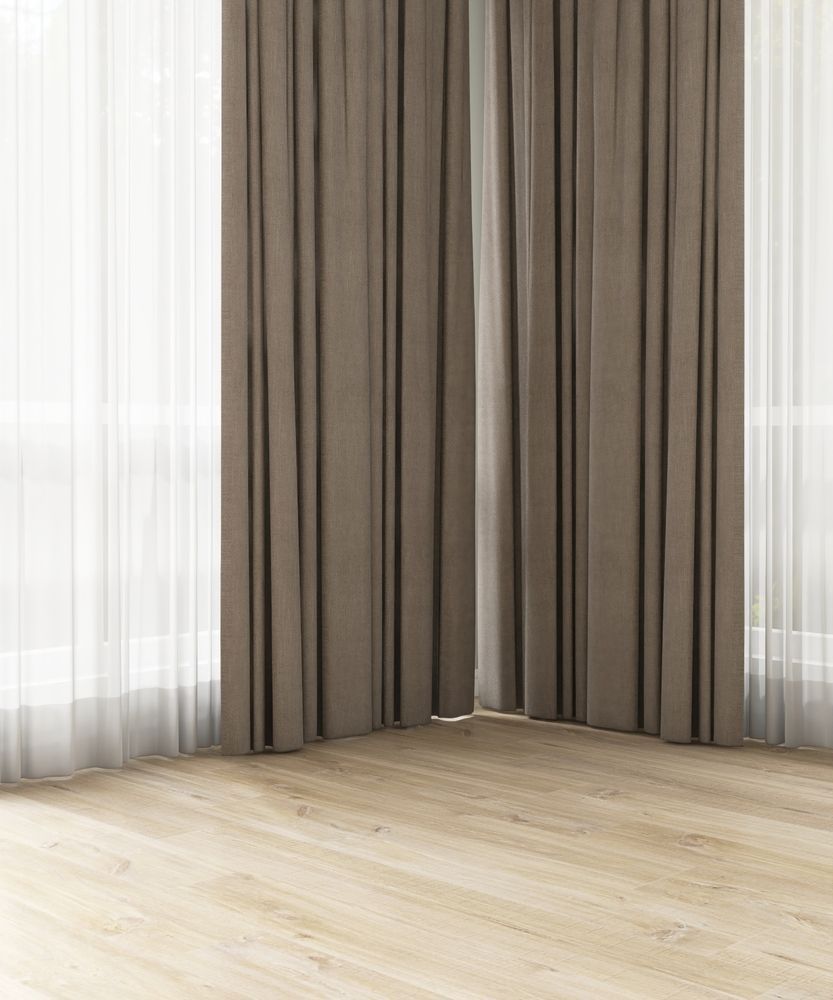 A room with gray walls, windows, curtains, and a mirror. Debris and equipment on the floor.