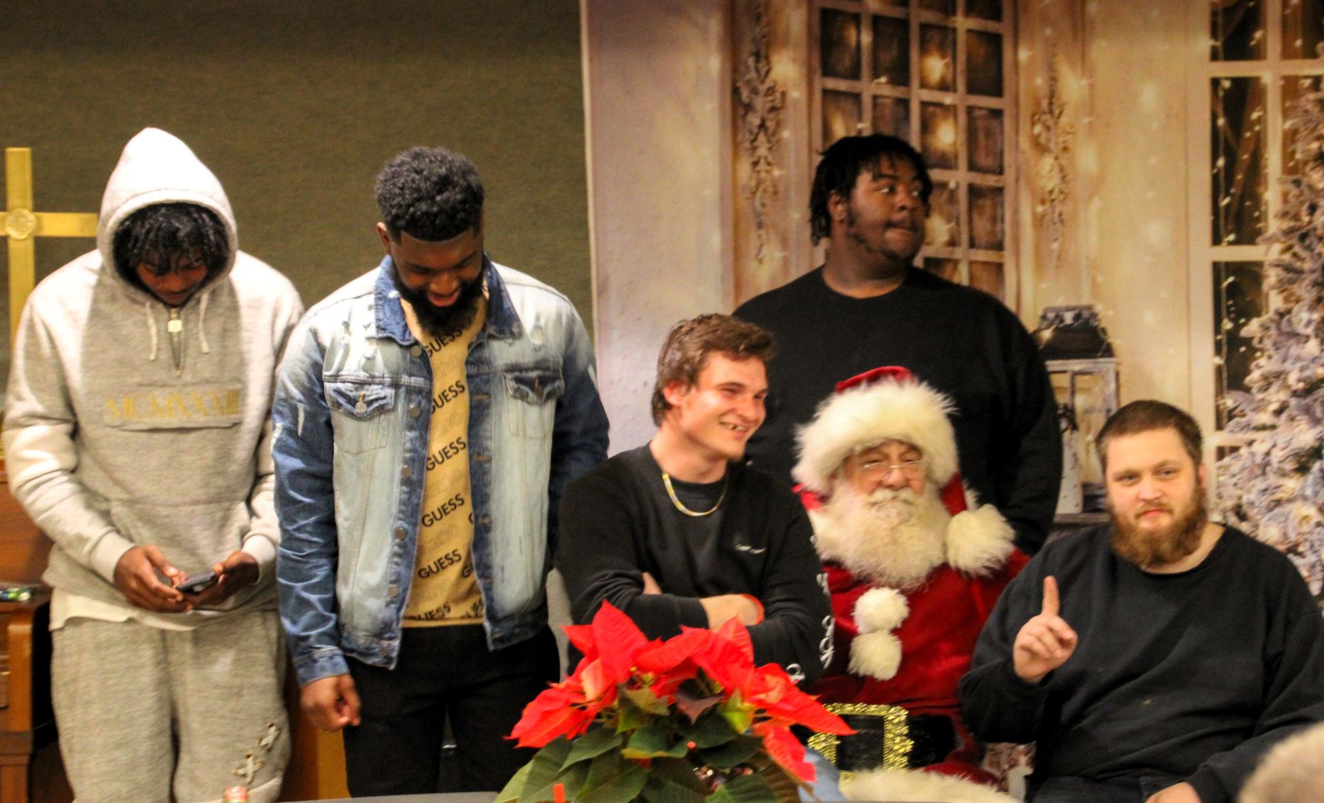 A group of men are posing for a picture with santa claus.