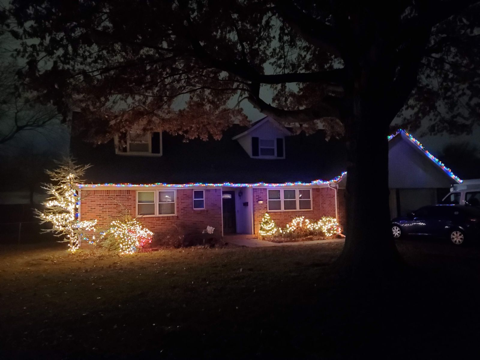 house at night with Christmas lights