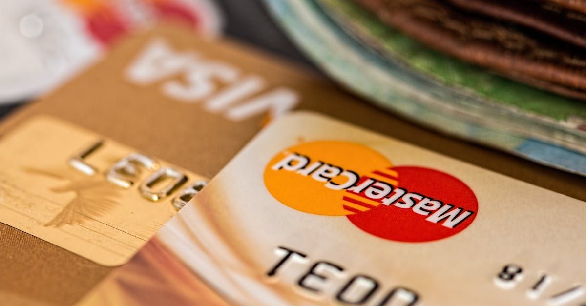 A close up of a mastercard and visa card on a table.