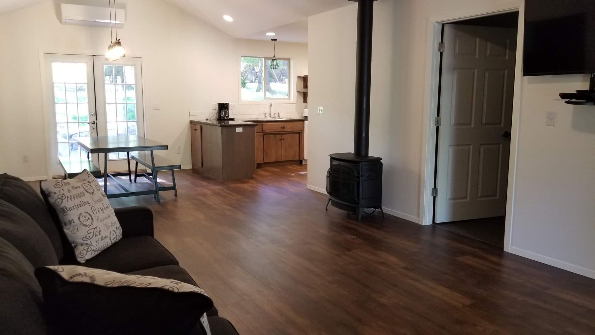 A living room with a couch , table , and television.