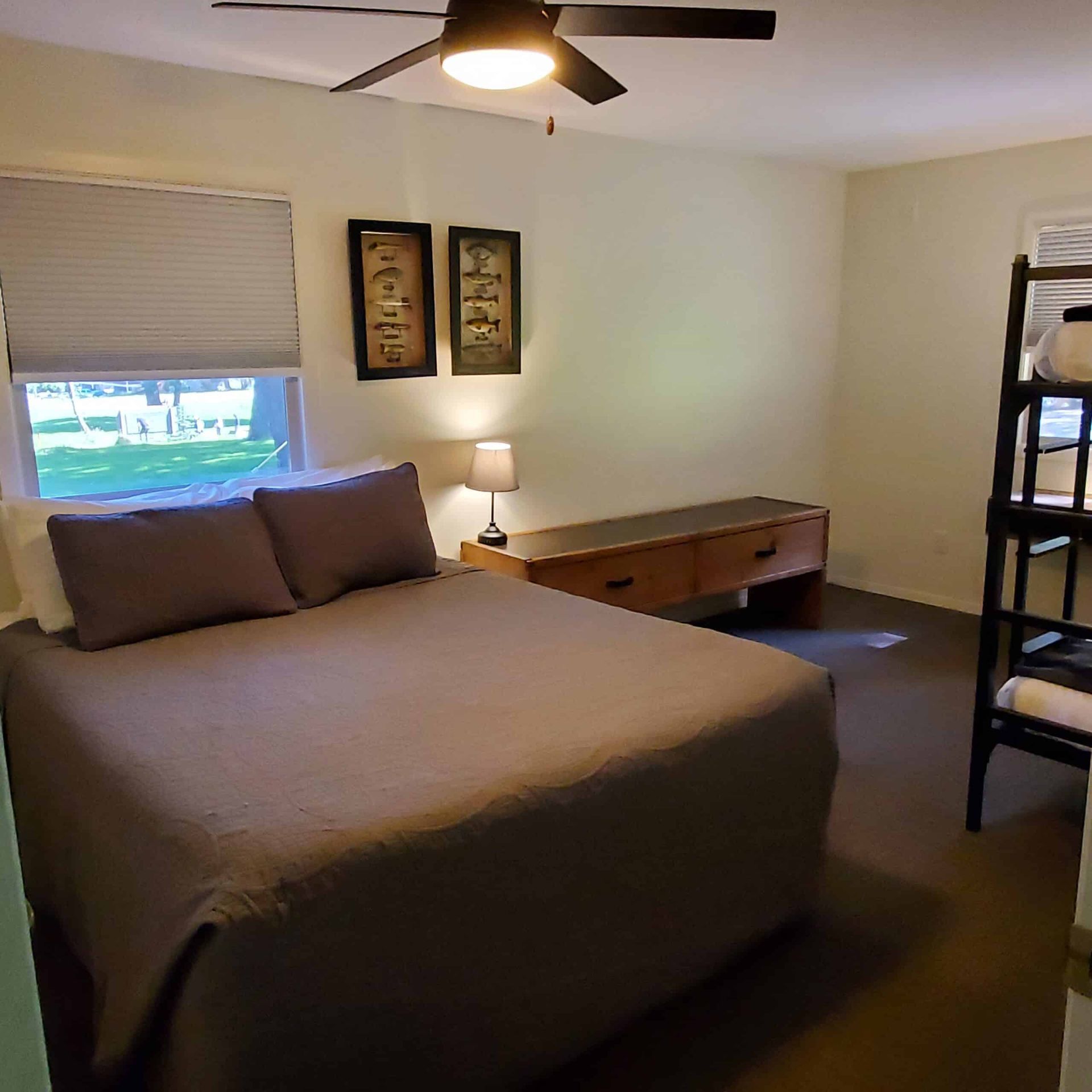 A bedroom with a bunk bed and a ceiling fan