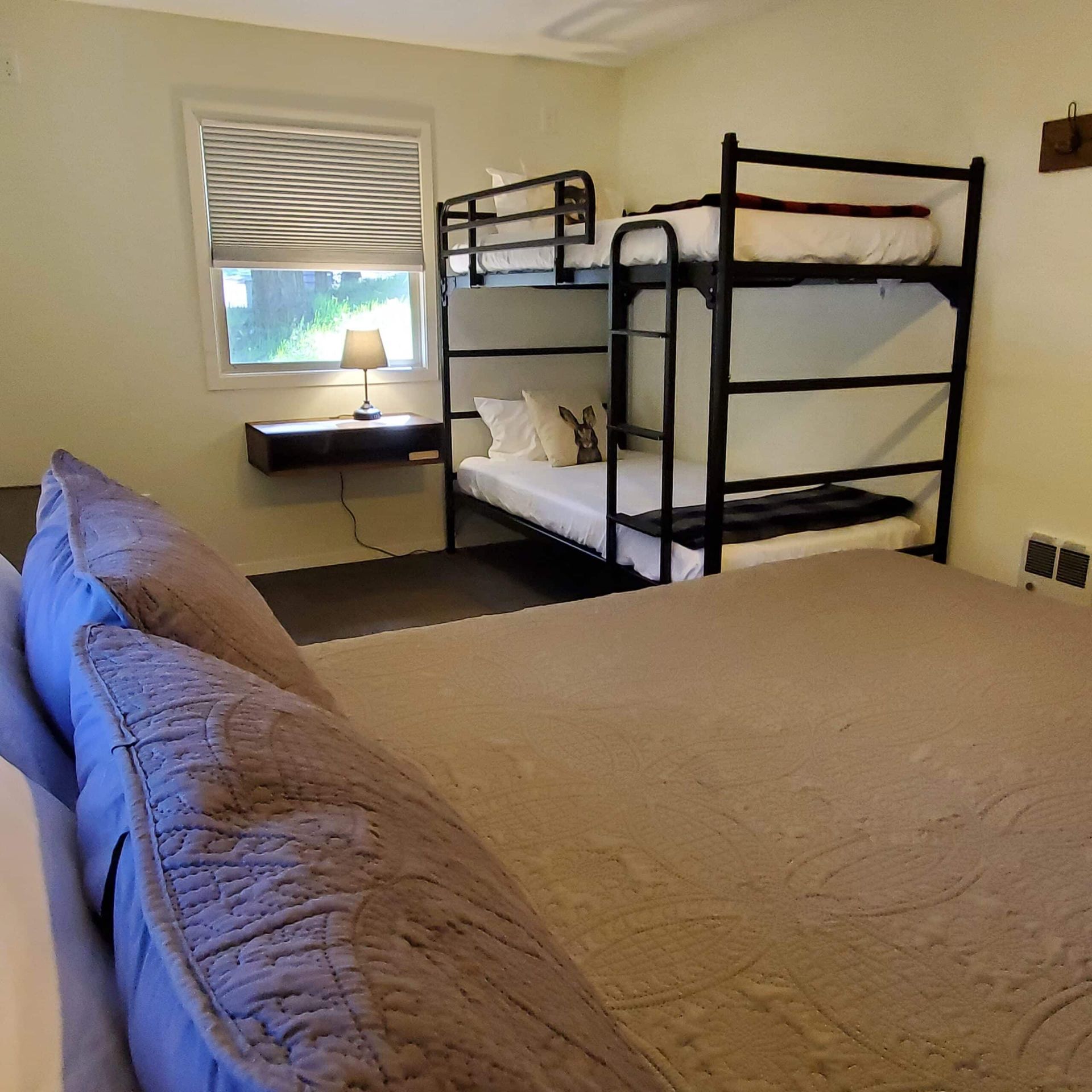 A bedroom with two bunk beds and a large bed