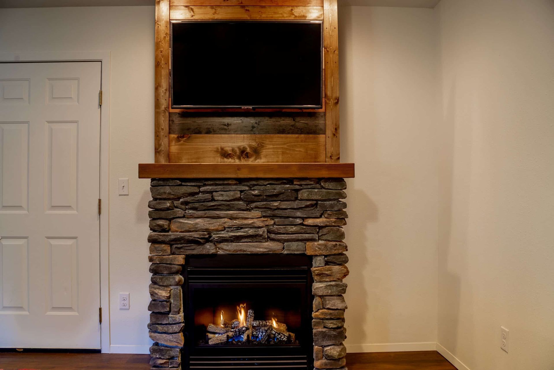 A fireplace with a flat screen tv mounted above it in a living room.