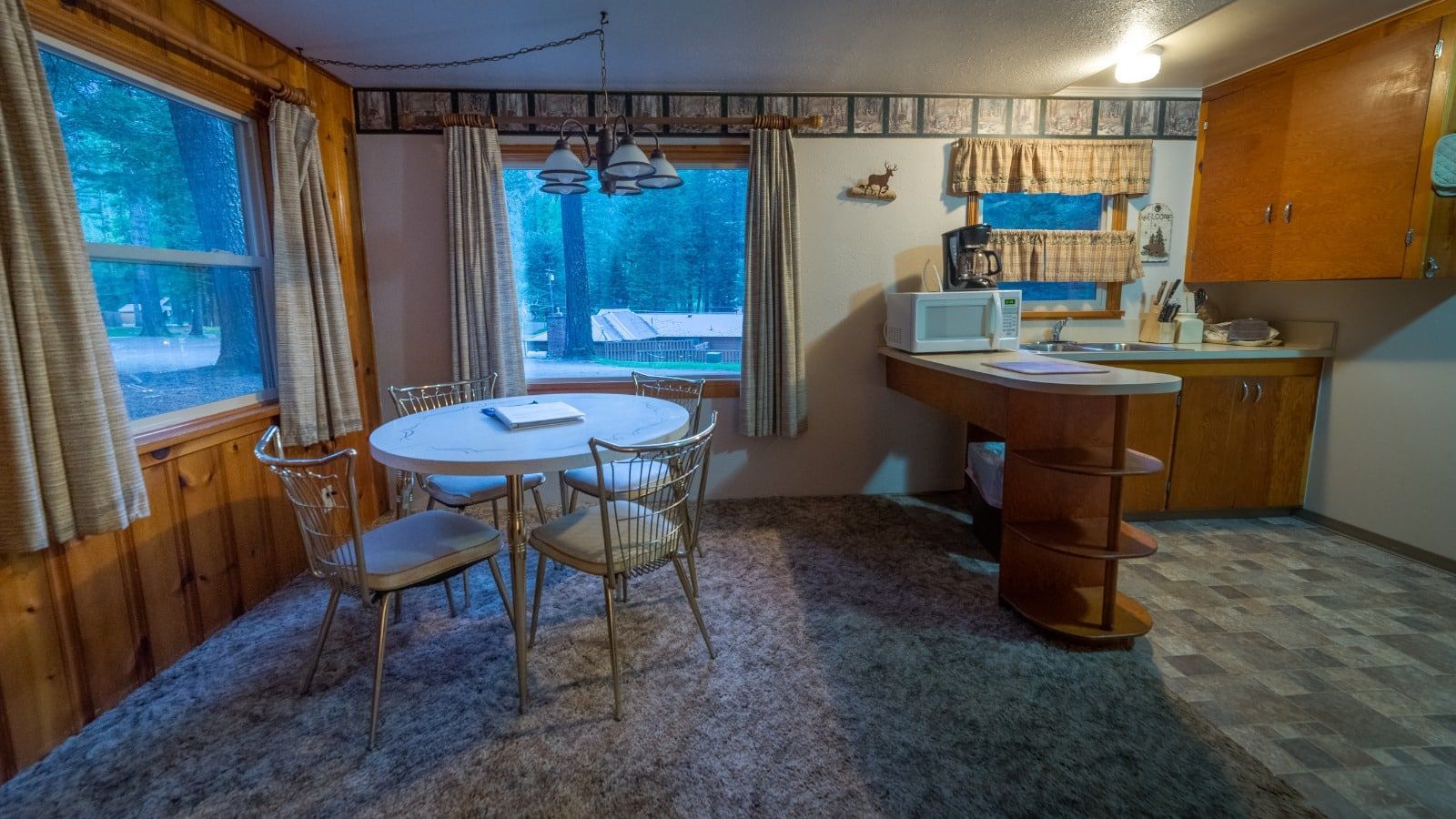 There is a table and chairs in the middle of the room.