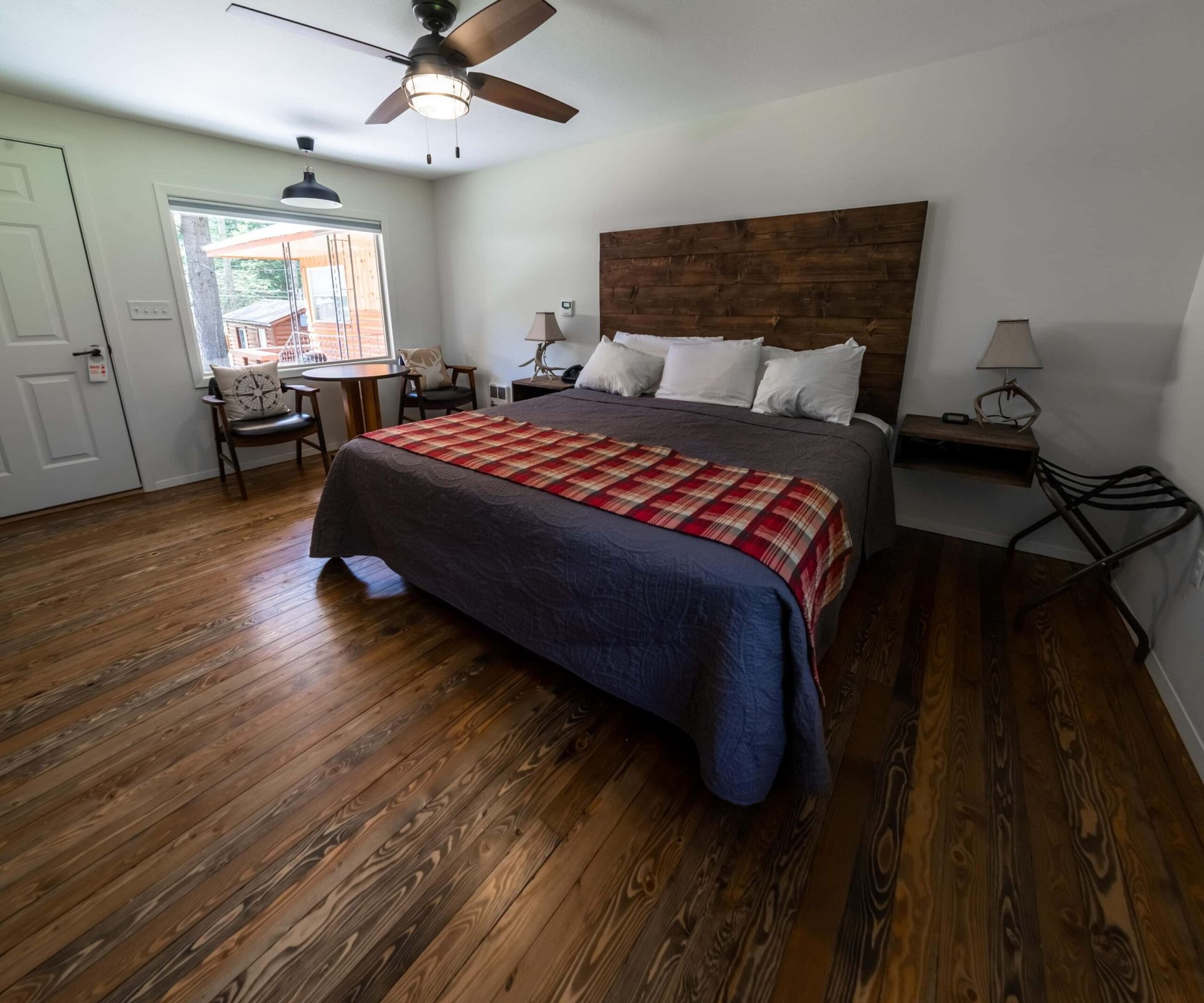 A bedroom with a large bed and a ceiling fan
