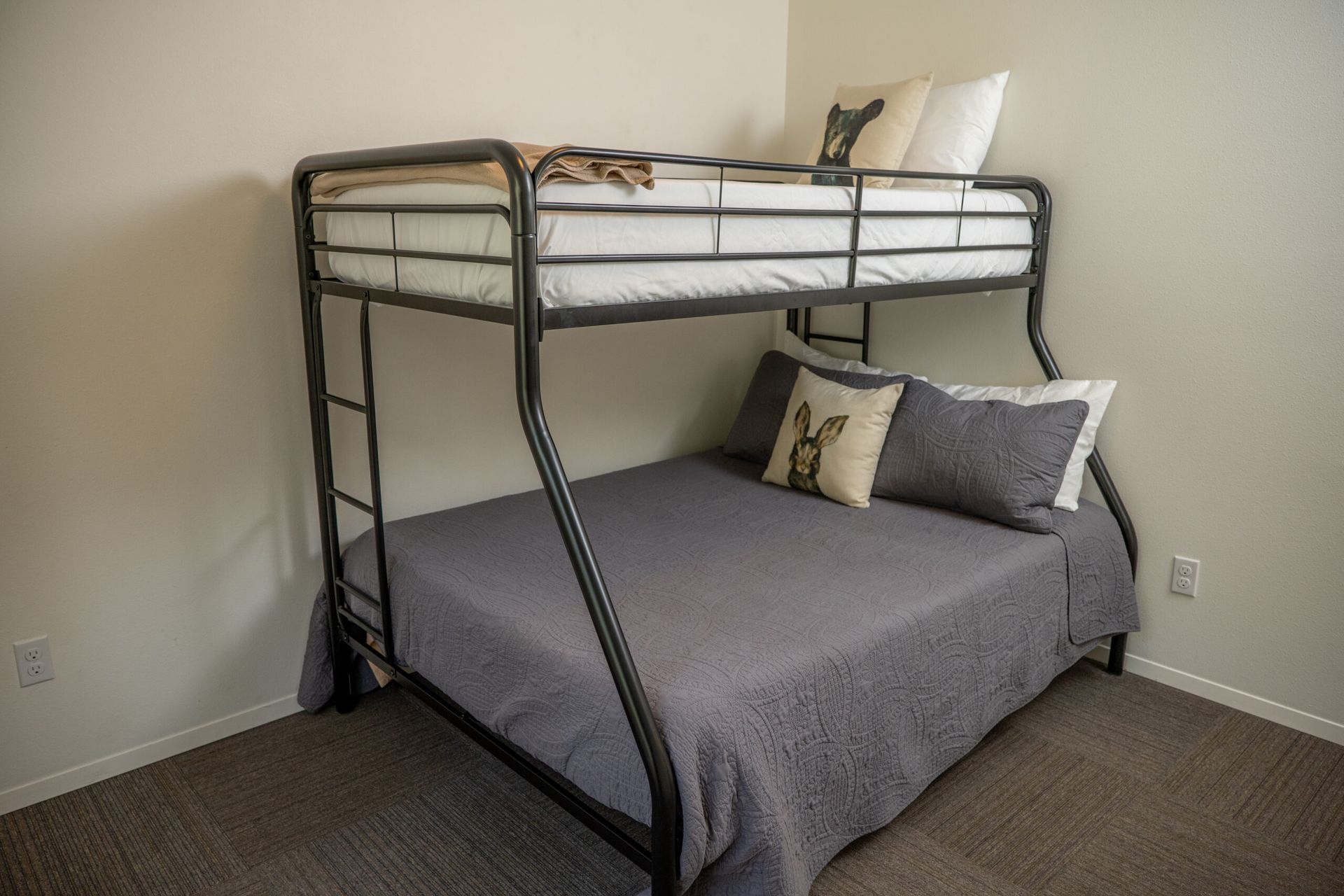 There is a bunk bed in the corner of the room.