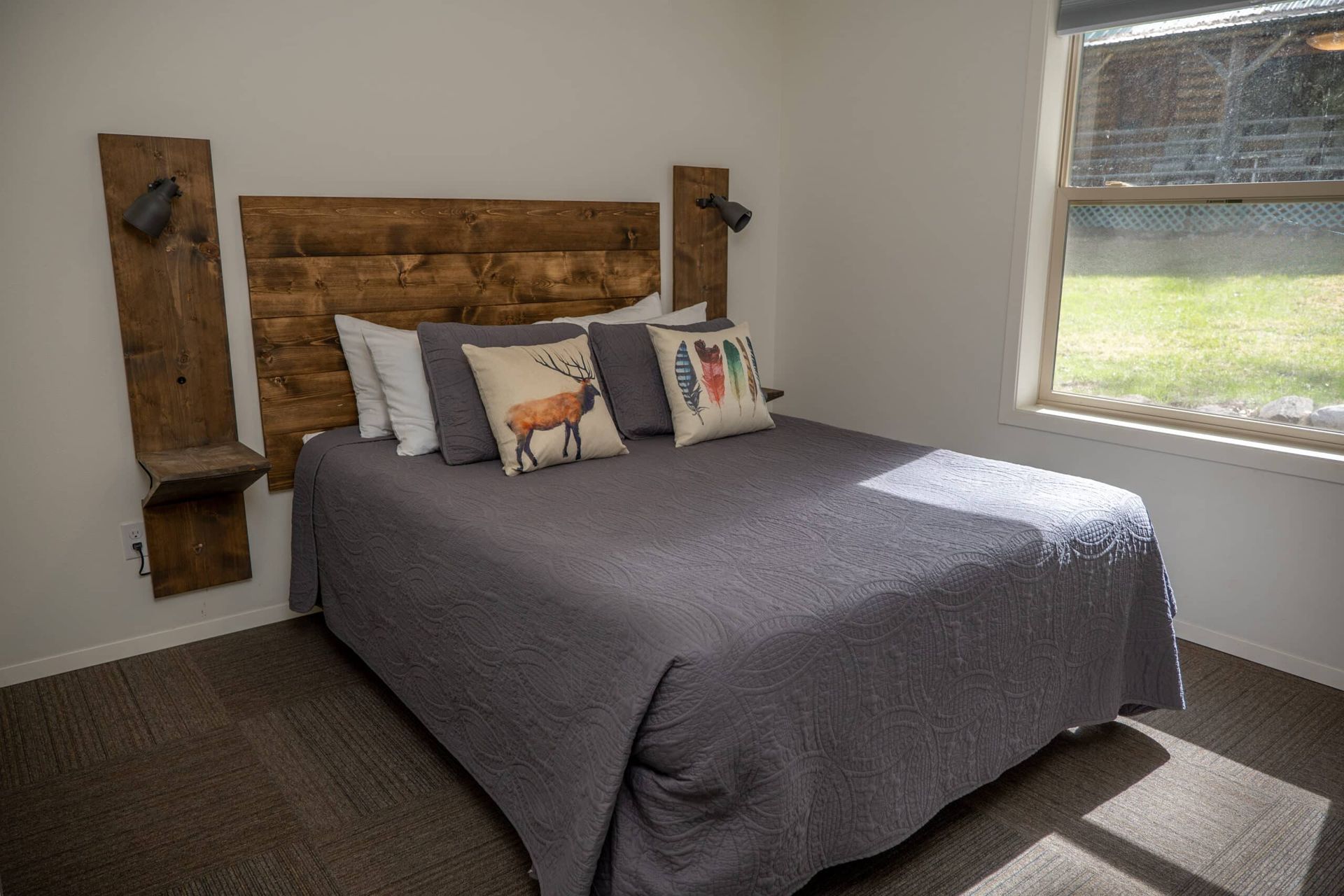 A bedroom with a king size bed and a wooden headboard.