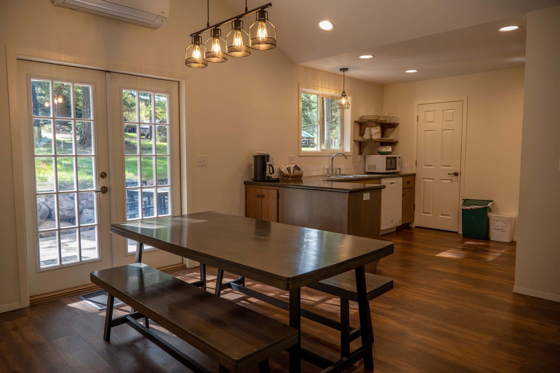 A kitchen with a table and benches in it.